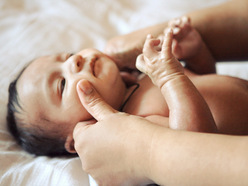 Baby getting massage on the face