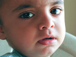 Wide-eyed anxious toddler.