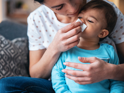 Mum wiping baby's nose with tissue