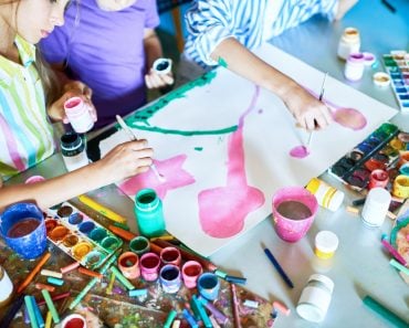 Group of unrecognizable children painting pictures with watercolors working together in art(SeventyFour)s