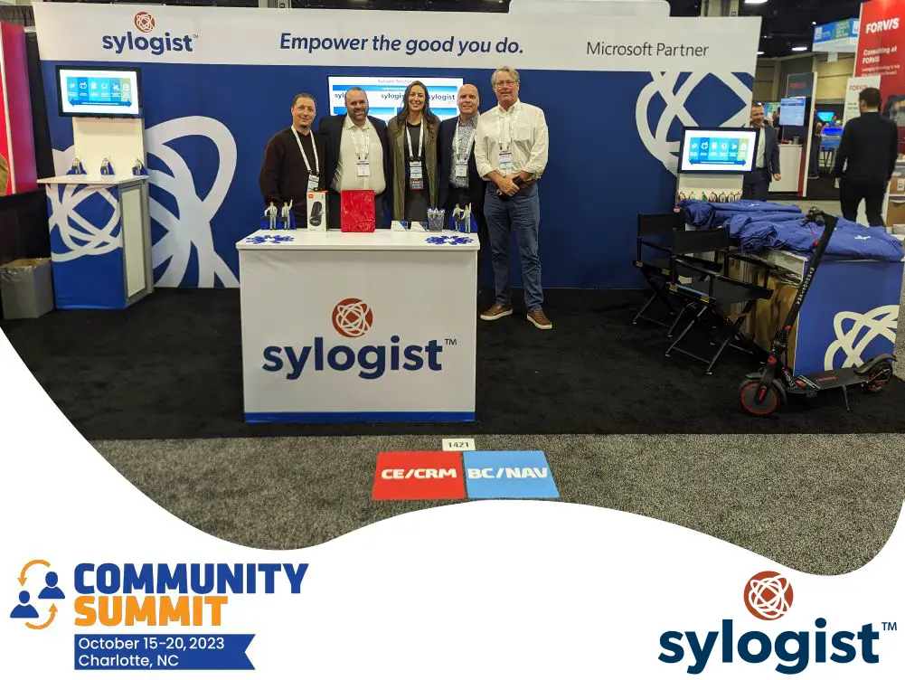 Image of the sylogist representatives posing at a booth for the community summit