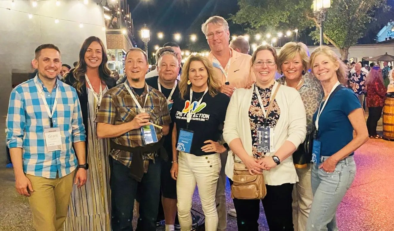 group of people standing together for a photo and smiling