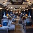 a blue plush interior of a luxury train