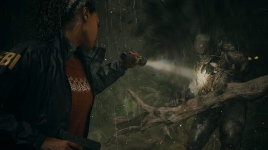 Best horror games: Saga Anderson using a flashlight on a Taken in Alan Wake 2