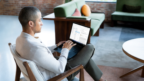 A person types at a laptop