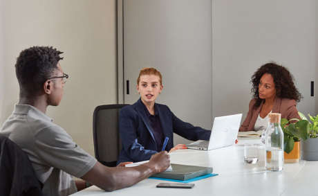 Three people in a meeting at a conference room