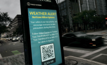 A weather alert is displayed along a sidewalk as Hurricane Milton churns in the Gulf of Mexico on October 07, 2024 in Tampa, Florida. Milton, which comes on heels of the destructive Hurricane Helene, has strengthened to a Category 5 storm as it approaches Florida’s Gulf Coast near Tampa, where it is projected to make landfall Wednesday.