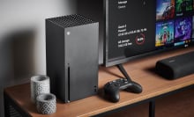 xbox series x on table next to tv