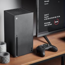 xbox series x on table next to tv