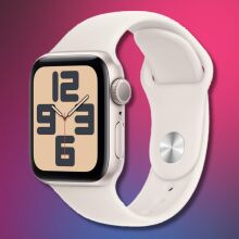 an apple watch se 2 with a starlight colored band on a pink and black gradient background