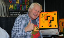 Charles Martinet posing with a Mario question block 