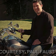 A man (Paul Faust as Paul Faust on "The Office") sitting on a motorcycle.