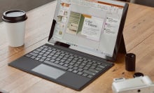 chromebook next to cup of coffee on desk