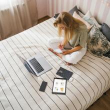 Girl with laptop on bed