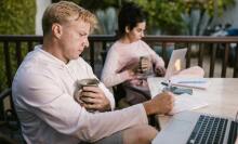 Couple looking at laptops