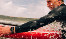 A surfer wearing an Apple Watch Series 10 in the water