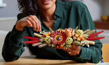 woman building Lego dried flower centerpiece kit