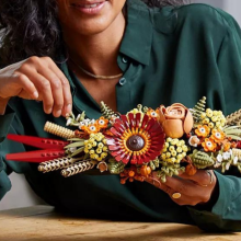 woman building Lego dried flower centerpiece kit