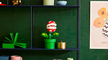 the LEGO Super Mario Piranha Plant on a black metal shelf surrounded by other knick-knacks