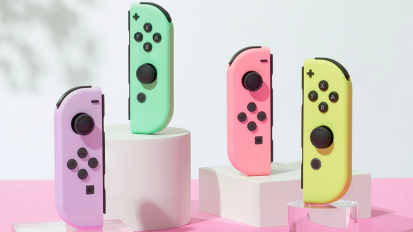 four pastel joy-con sitting on white and clear blocks on a pink surface