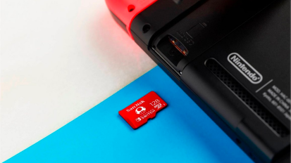 a close-up of a sandisk microsd card next to a nintendo switch