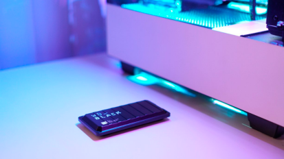 a WD_BLACK P50 Game Drive SSD in front of a lit-up gaming pc