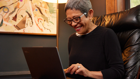 A person smiling at a Surface device