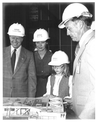 President Carter, wife Rosalynn and daughter Amy are shown a scale model of the crawler that transported the total shuttle launch configuration to Pad 39 from the Vehicle Assembly Building by NASA’s Kennedy Space Center Director Lee Scherer in 1978. Credit: NASA