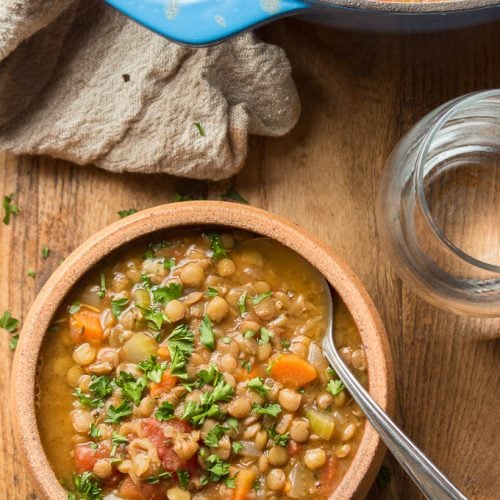 Table Set with a Bowl of Lentil Soup, Blue Pot and Water Glass