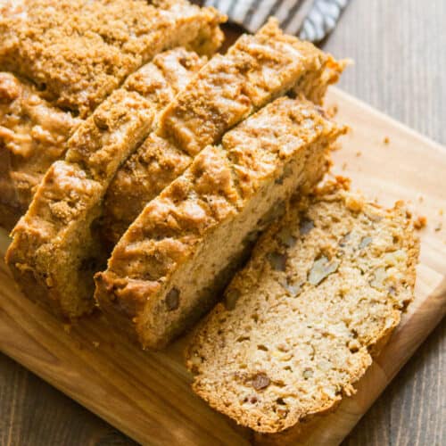 Sliced loaf of Vegan Banana Bread on a cutting board.