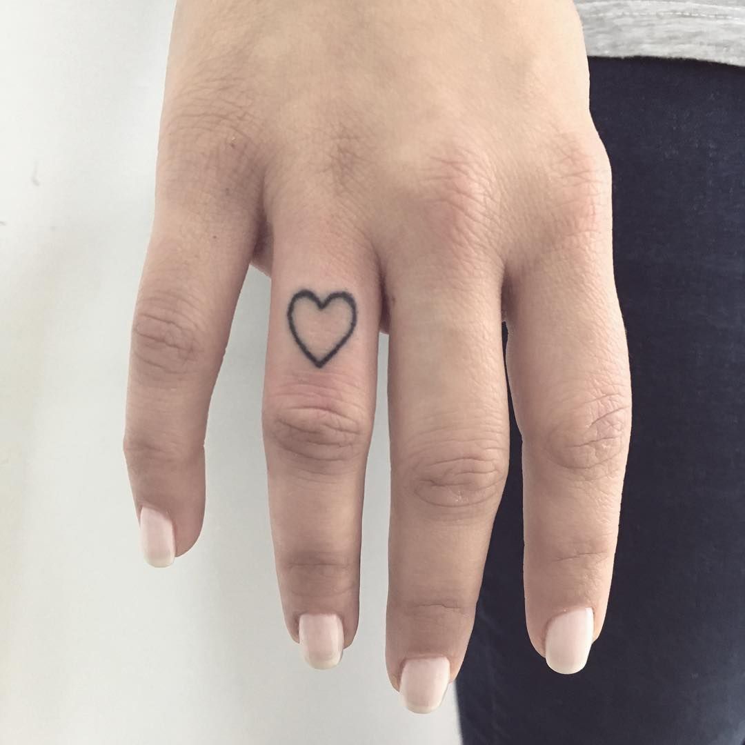 Small heart tattoo by Gianina Caputo inked on the right hand’s ring