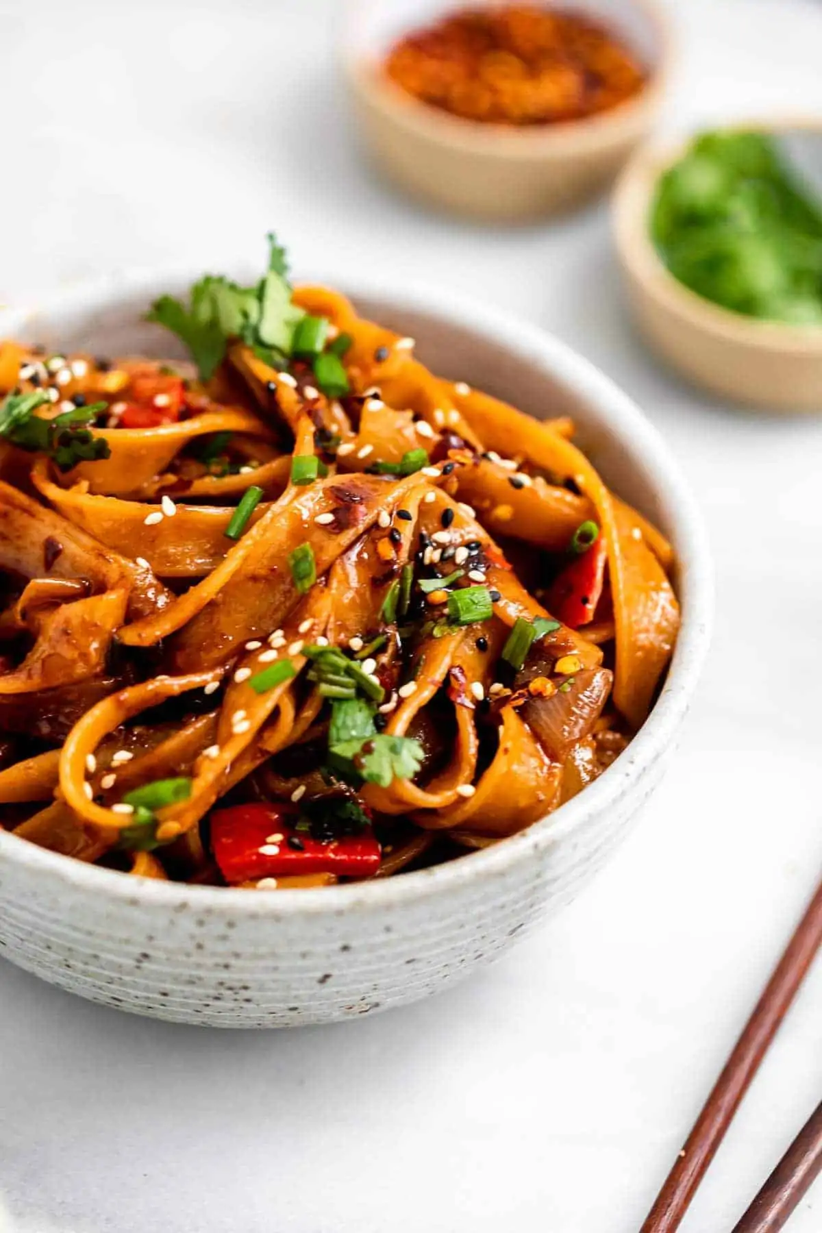 angled view of the noodles with red peppers