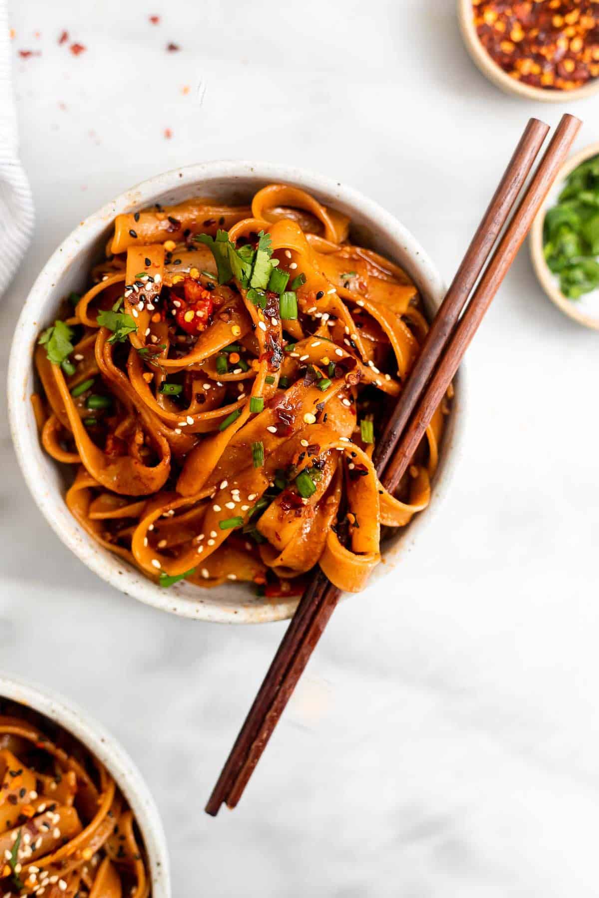 spicy noodles with chopsticks wrapped around the noodles