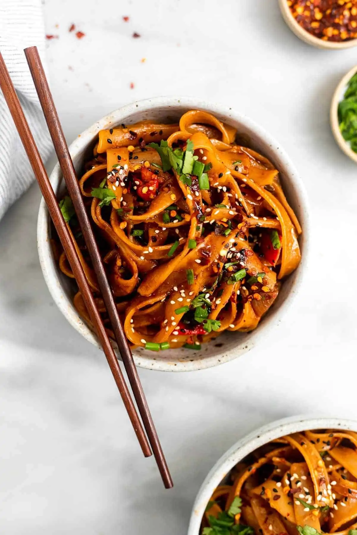 spicy chili garlic noodles in a bowl with chopsticks