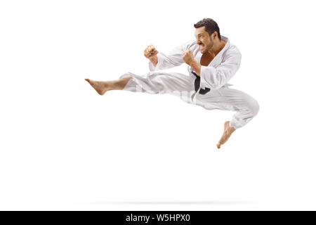 Full length shot of a man performing flying kick in martial arts isolated on white background Stock Photo