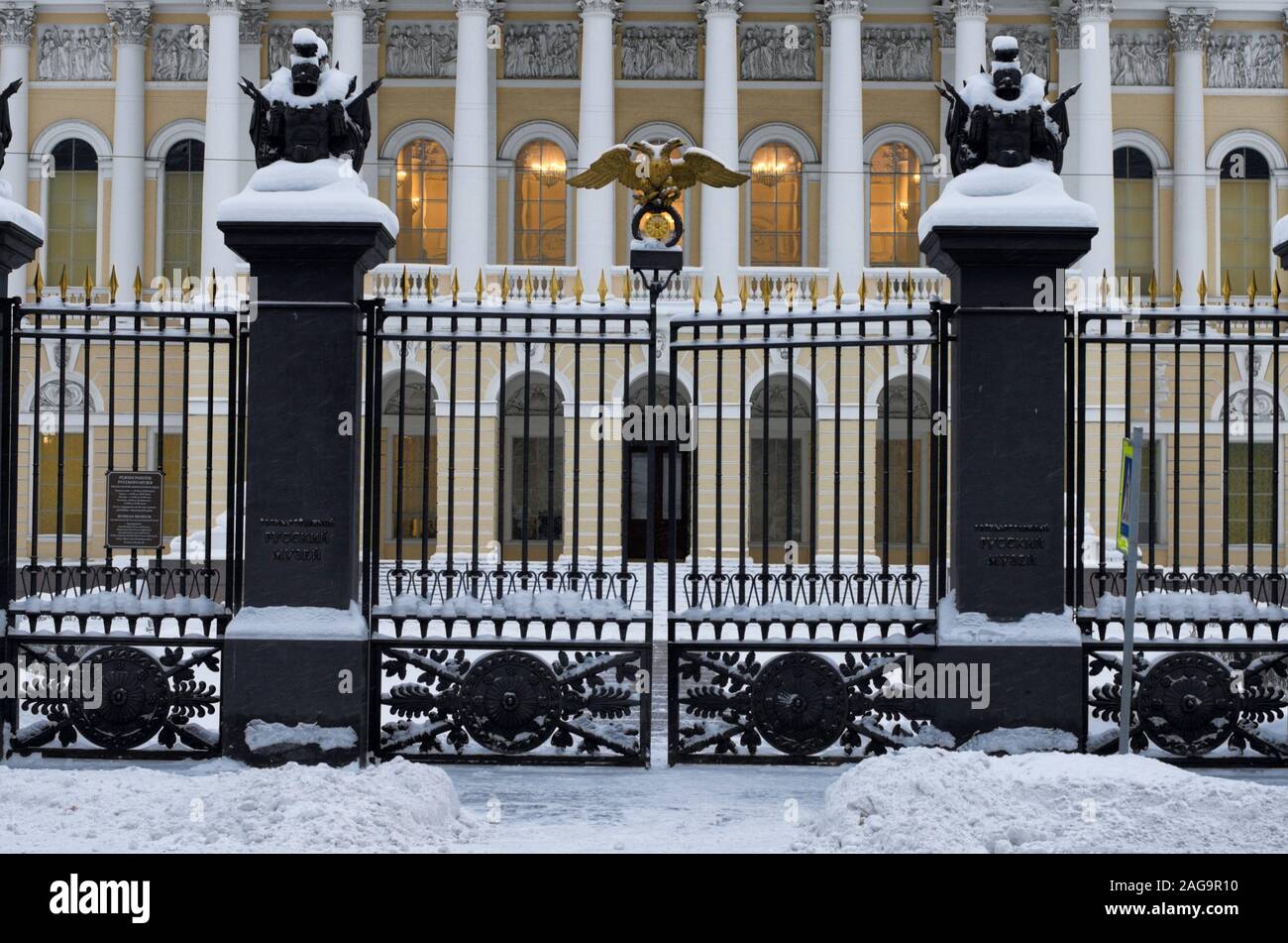 In winter twilight the gate with a double-headed Golden eagle and a lattice leading to the State Russian Museum (St. Petersburg, Russia) Stock Photo