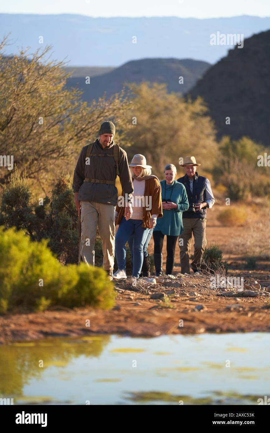 Safari tour guide leading group on sunny wildlife reserve Stock Photo