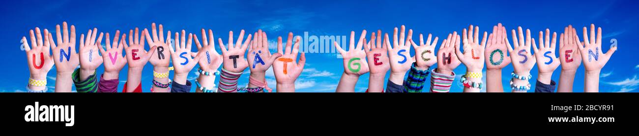 Hands Building Word Universitaet Geschlossen Means University Closed, Blue Sky Stock Photo