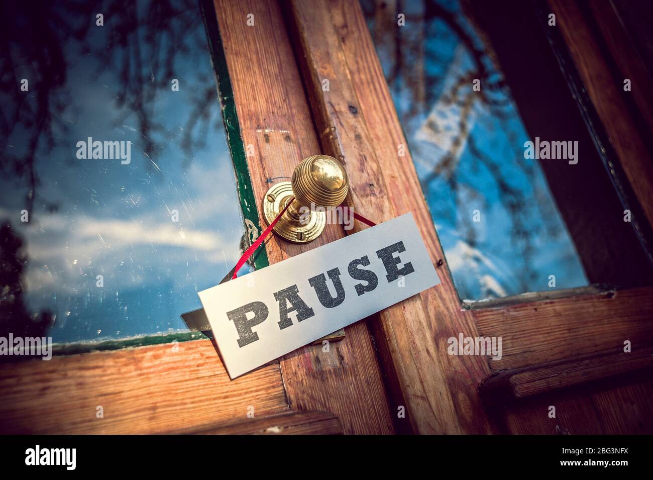 Old Shop-Door with 'Pause' Sign Stock Photo