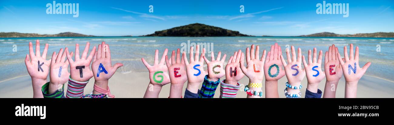 Hands Building Word KITA geschlossen Means Kindergarden Closed, Ocean Background Stock Photo