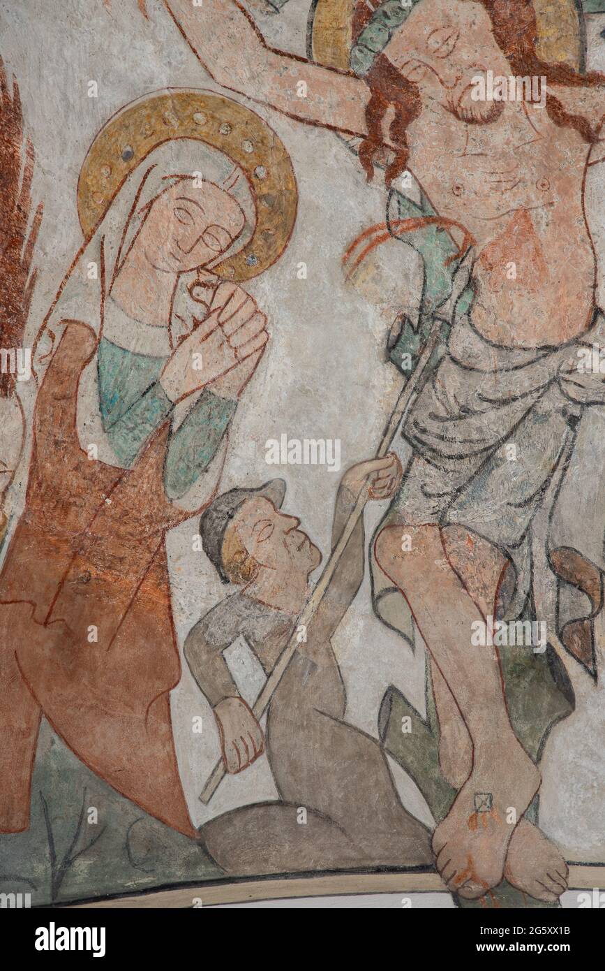 The Roman soldier Longinus pierces the side of Jesus with his spear and the blood come upon his eyes, so he could see again. An old mural in Skibby ch Stock Photo