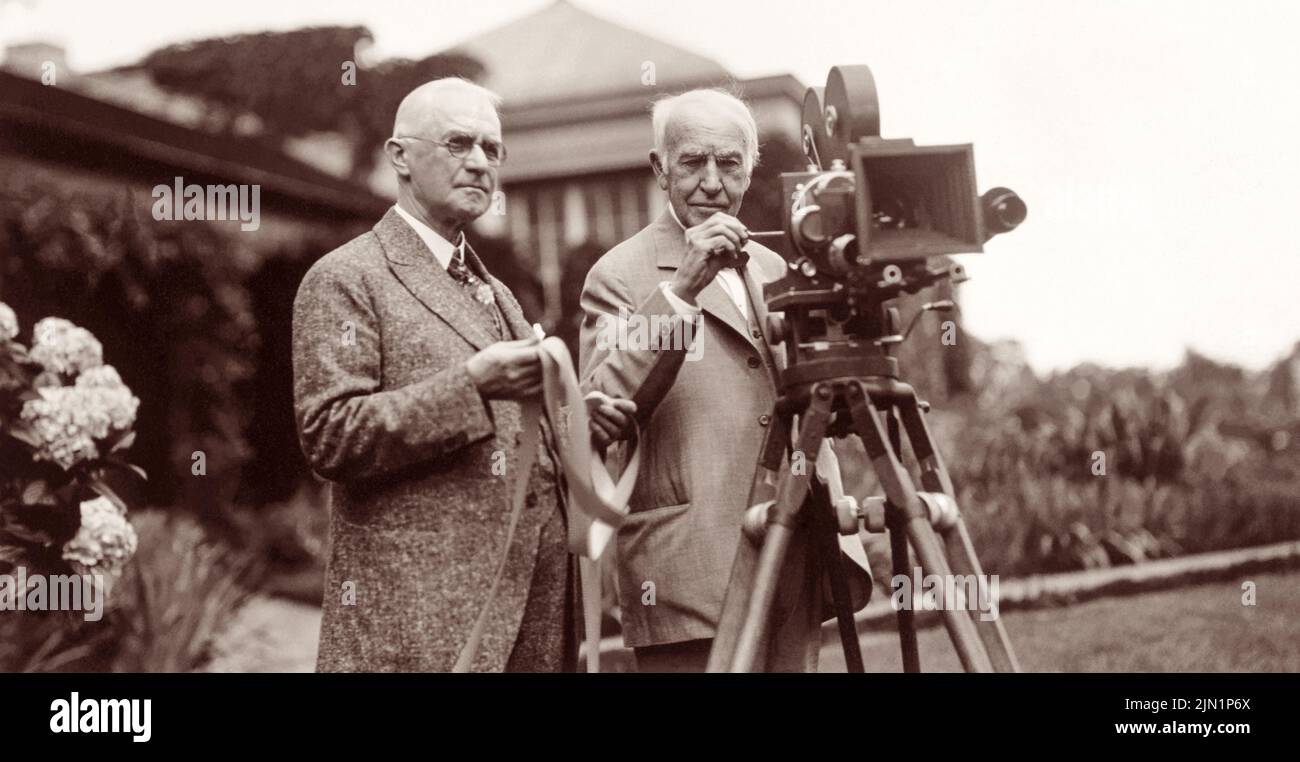 George Eastman (left) and Thomas Edison in July 1928, with motion picture camera at Eastman's house in Rochester, New York, where a demonstration of the new Kodacolor film was being held. (USA) Stock Photo