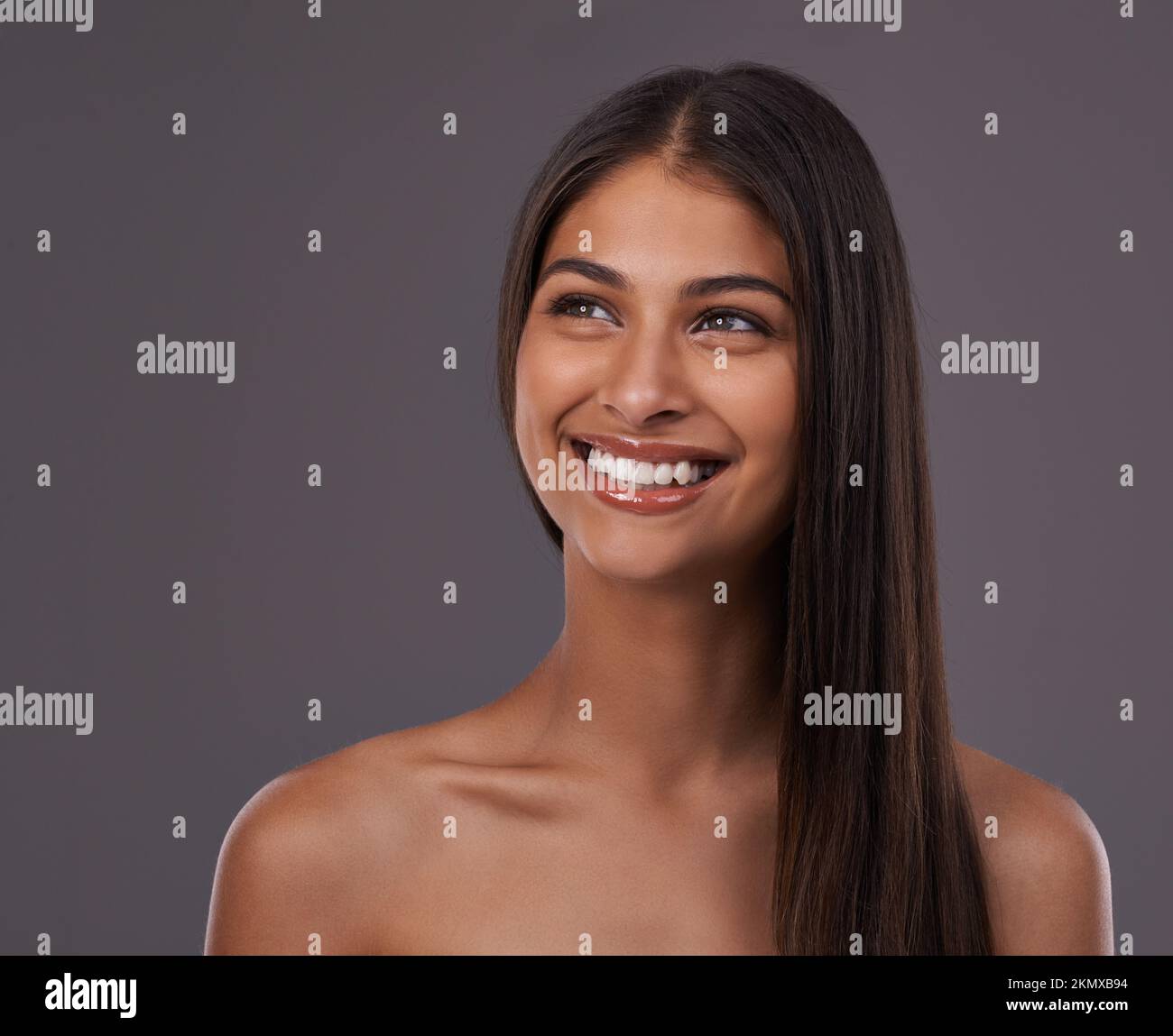 Feeling filled with confidence. A young woman with sleek hair posing in studio. Stock Photo