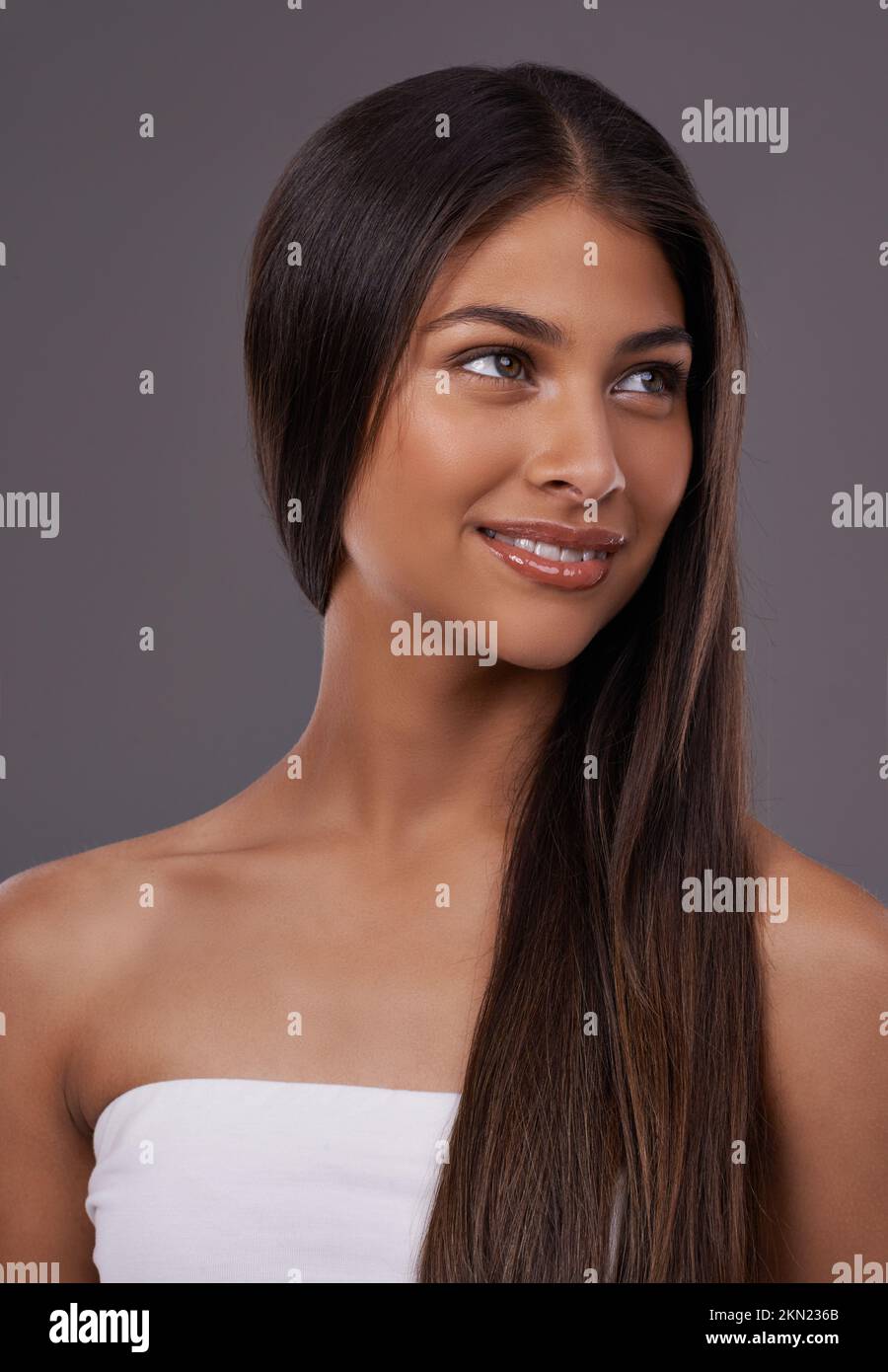 Natural confidence and beauty. A young woman with sleek hair posing in studio. Stock Photo