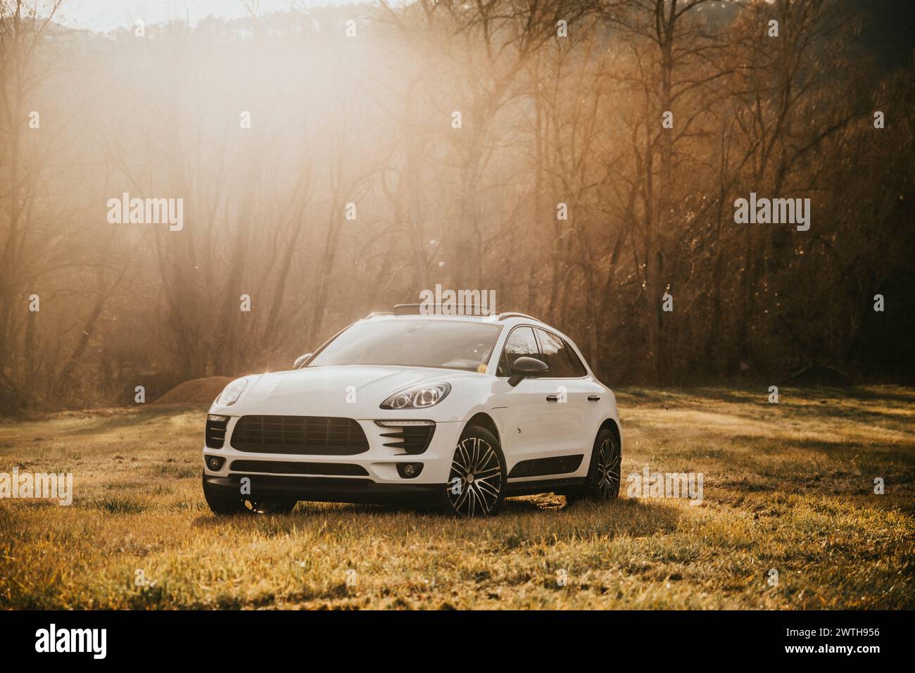 Sleek White Car Drifting in Mountainous Terrain Stock Photo