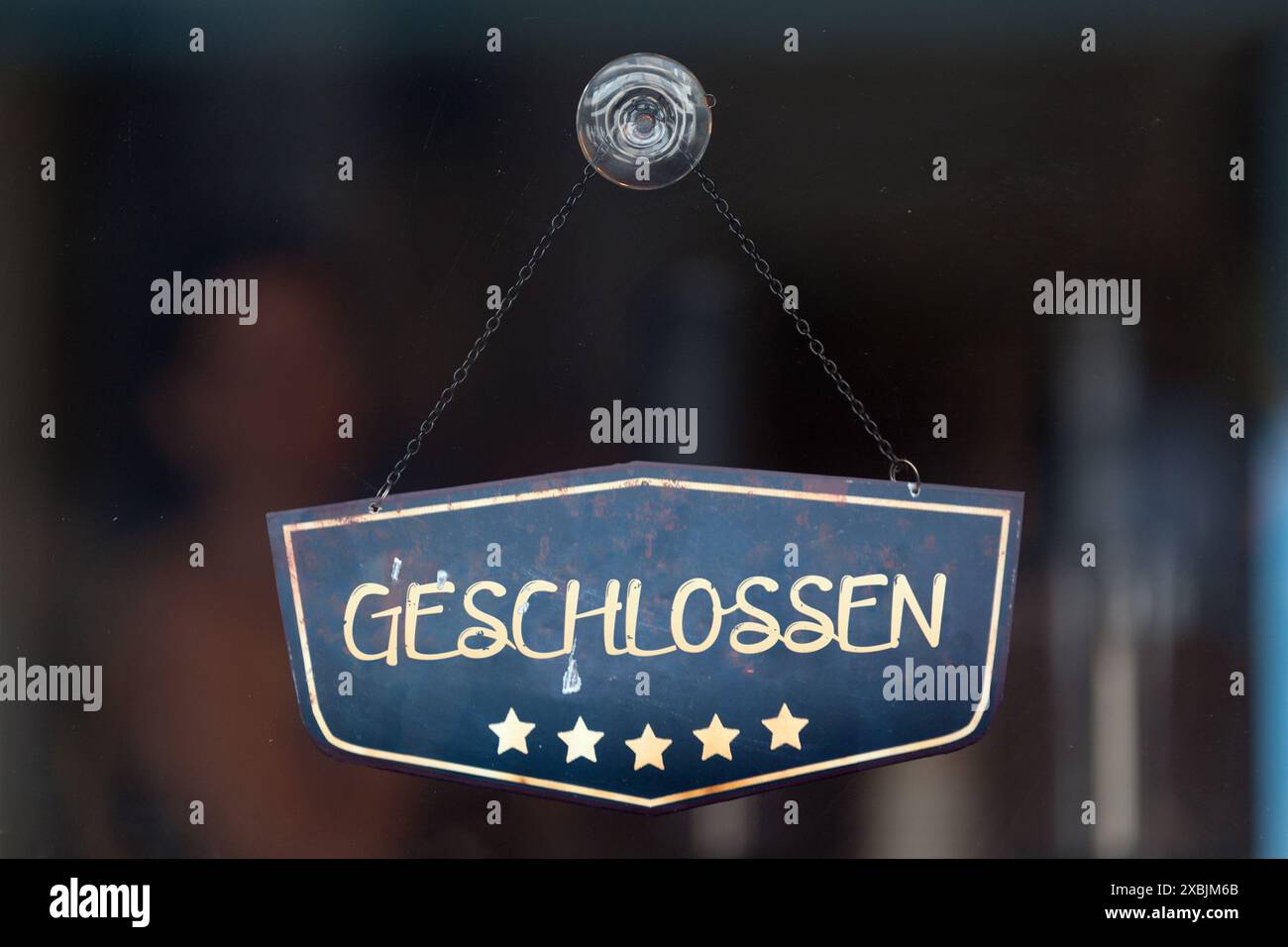 Old fashioned sign in the window of a shop saying in German 'Geschlossen', meaning in english 'Closed'. Stock Photo