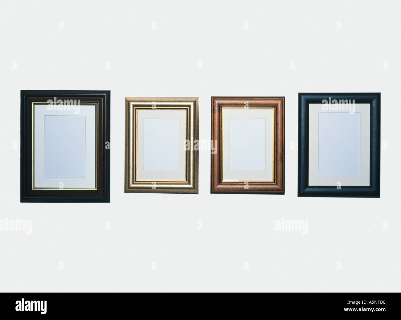 Four empty picture frames on a wall Stock Photo