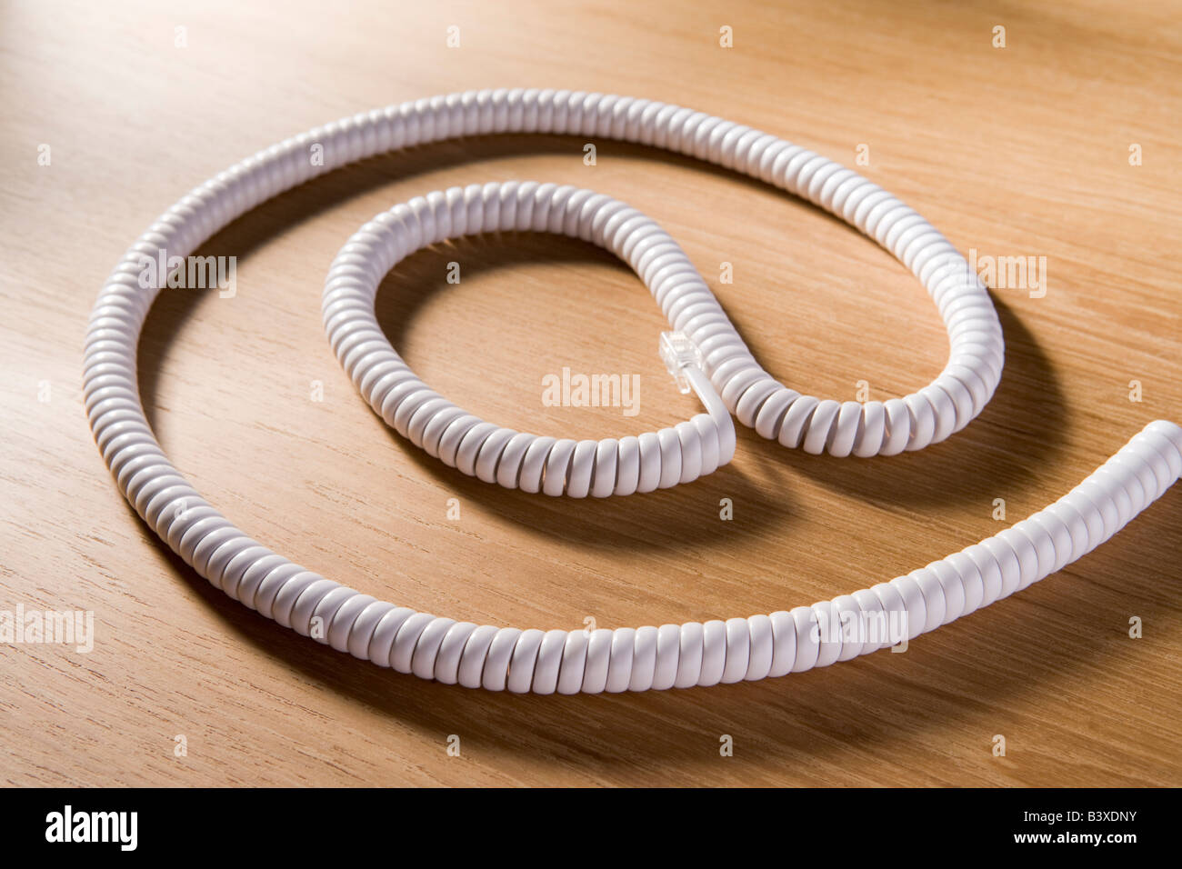 Telephone Cord Making 'At' Symbol Stock Photo