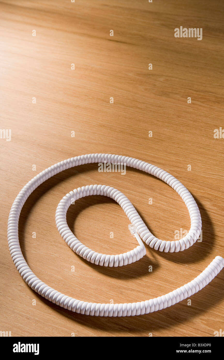 Telephone Cord Making 'At' Symbol Stock Photo