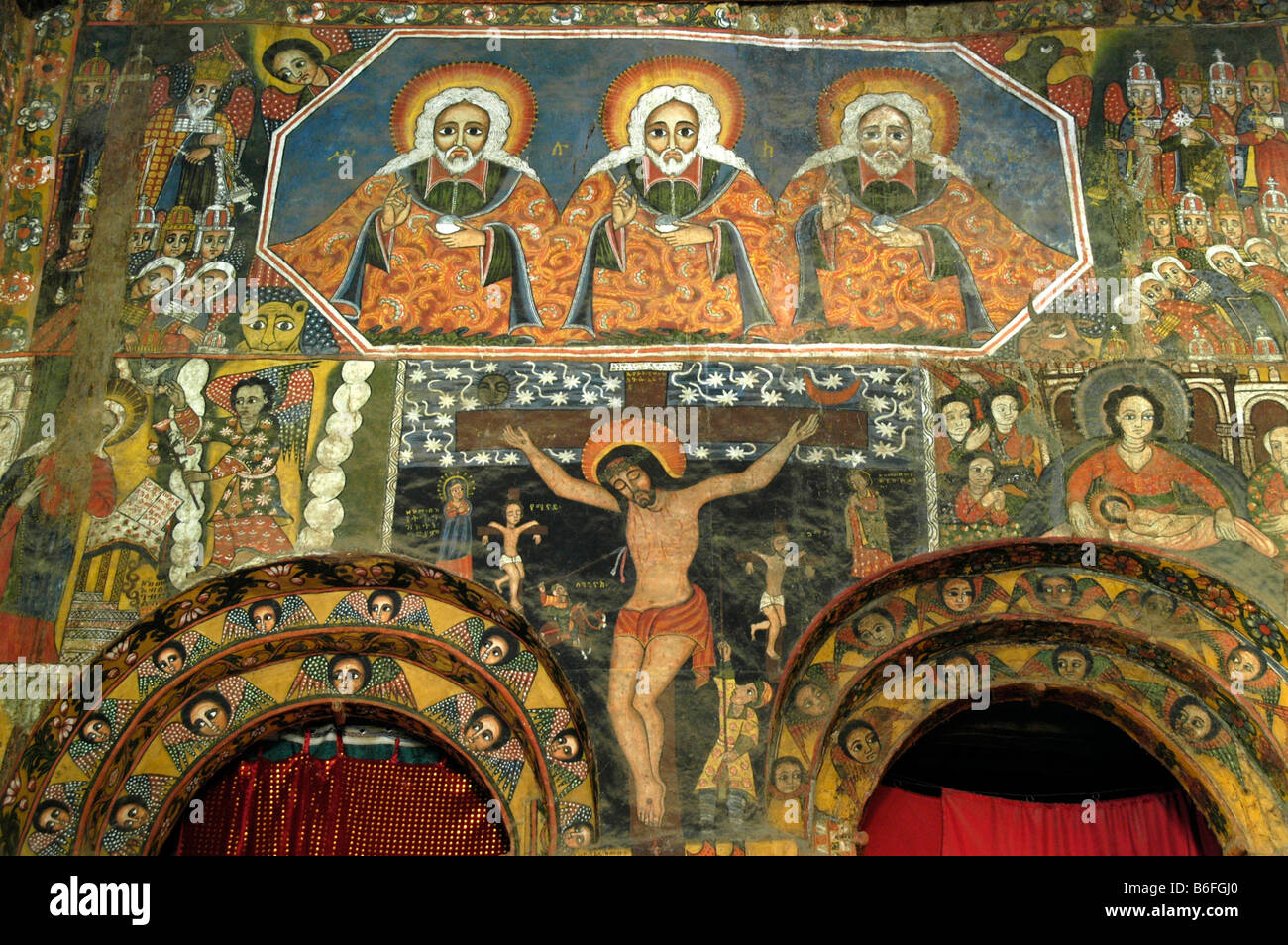 Ethiopian Orthodox Christianity, wall painted with the Holy Trinity over an image of Christ on the cross, in the Church of the  Stock Photo